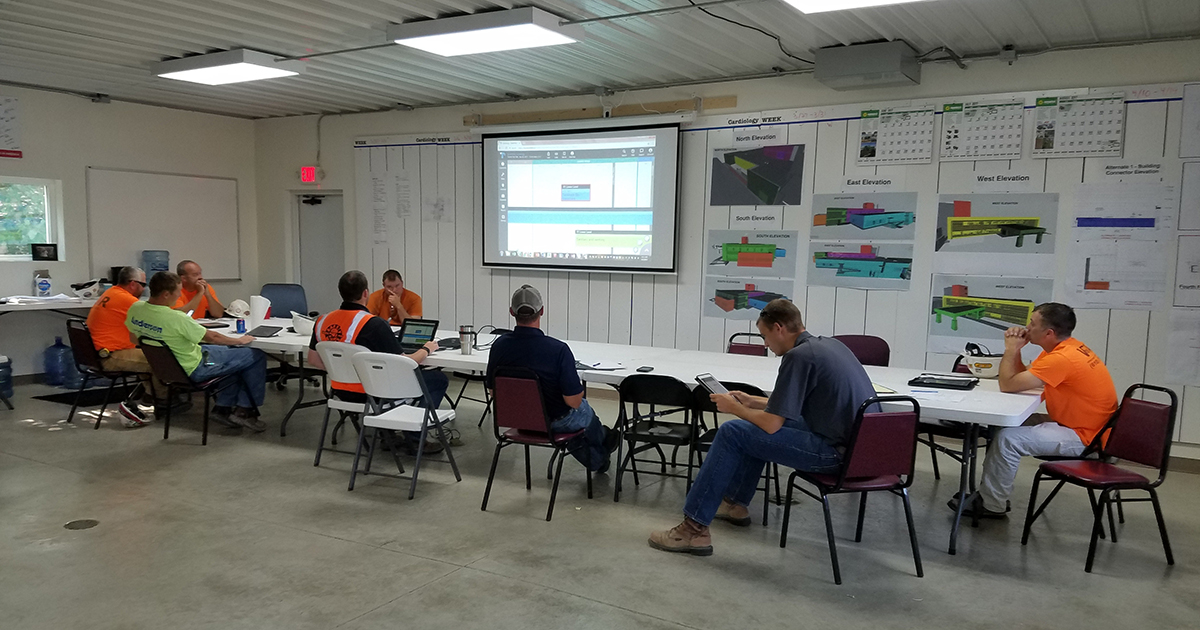 Group of construction professionals using Touchplan in the trailer